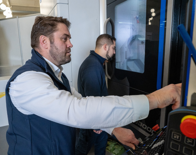 NCMT applications engineer delivering practical CNC machine tool training on Okuma machining centre.
