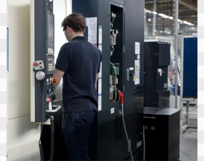 Customer operator applying CNC machine training independently at their own facility, operating control panel with confidence and efficiency.