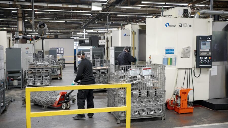 EV Component Production on Makino a61nx Machining Centres Makino a61nx horizontal machining centre in UK manufacturing facility with operators handling aluminium EV components for precision automotive production
