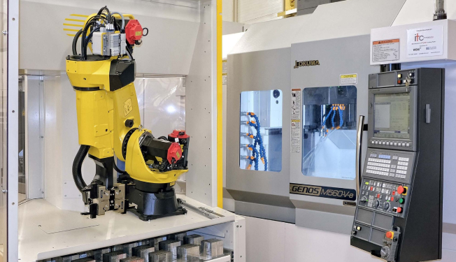 AUT - 2 Automated CNC machining cell with industrial robot loading parts into an Okuma GENOS M560-V machining centre.