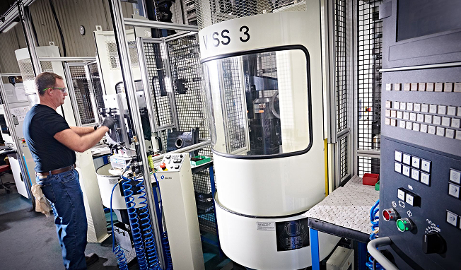 AUT -3 Operator setting up a Makino VSS3 vertical machining centre in a precision CNC machining environment.