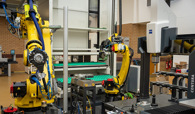 AUT -5 Industrial robots integrated with a coordinate measuring machine (CMM) for automated inspection and quality control in precision manufacturing.