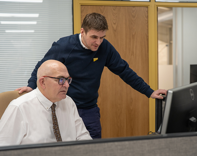 NCMT technical support team reviewing service data and spare parts requirements for CNC machine tools.