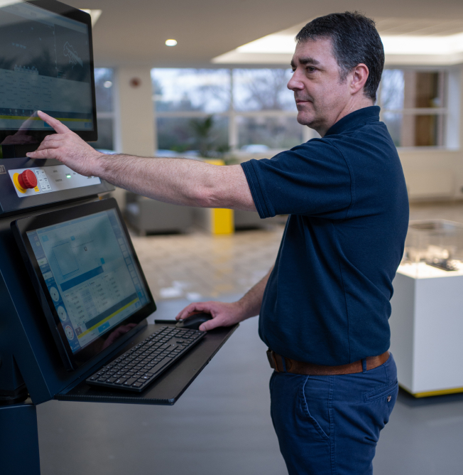 checker Engineer operating EDM machine control interface in NCMT Technology Centre, demonstrating advanced electrical discharge machining capability.